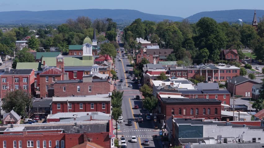 Take in the stunning aerial view of Charles Town, West Virginia, showcasing Main Street and the historic Jefferson County Courthouse on a sunny autumn day.