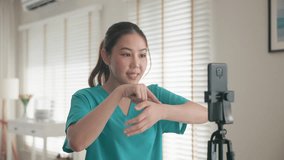 Young adult woman asia people anti aging expert modern nurse live talk video call selfie camera mobile phone app mental health care Online digital virtual asian vlogger filming hand wrist pain physio. - Powered by Shutterstock - Get 15% off with code: PIKWIZARD15