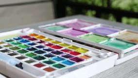 Female artist hand holds paint brush, mixing color oil. Creating new picture. man hands painting watercolor picture on paper with brush at table. Multiple acrylic. creative drawing art. hobby skill - Powered by Shutterstock - Get 15% off with code: PIKWIZARD15