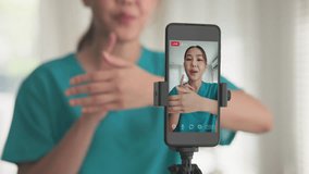 Young adult woman asia people anti aging expert modern nurse live talk video call selfie camera mobile phone app mental health care Online digital virtual asian vlogger filming hand wrist pain physio. - Powered by Shutterstock - Get 15% off with code: PIKWIZARD15