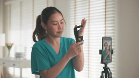 Young adult woman asia people anti aging expert modern nurse live talk video call selfie camera mobile phone app mental health care Online digital virtual asian vlogger filming hand wrist pain physio. - Powered by Shutterstock - Get 15% off with code: PIKWIZARD15