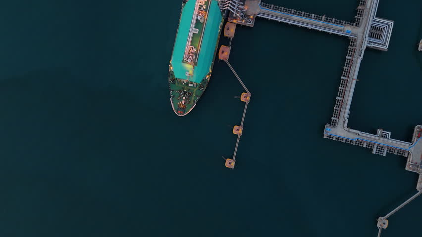 LNG (Liquified Natural Gas) tanker anchored in Gas terminal gas tanks for storage. Oil Crude Gas Tanker Ship. LPG at Tanker Bay Petroleum Chemical or Methane freighter export import transportation
