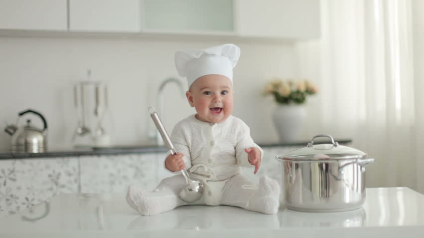 Happy little chef with a ladle