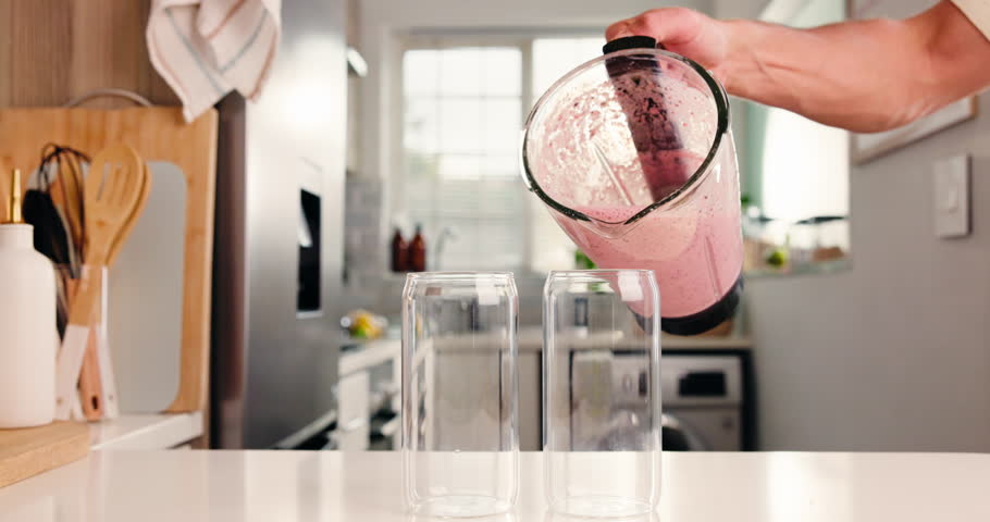 Pour, blender and smoothie with hands of person in kitchen for diet, detox and nutrition. Antioxidants, gut health and weight loss with man and drink in home for protein shake, fiber and vitamins