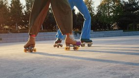 Young quad dancer legs with vintage roller skates in sunset park closeup. Trained girl friends perform graceful moves skating on city ground slow motion - Powered by Shutterstock - Get 15% off with code: PIKWIZARD15