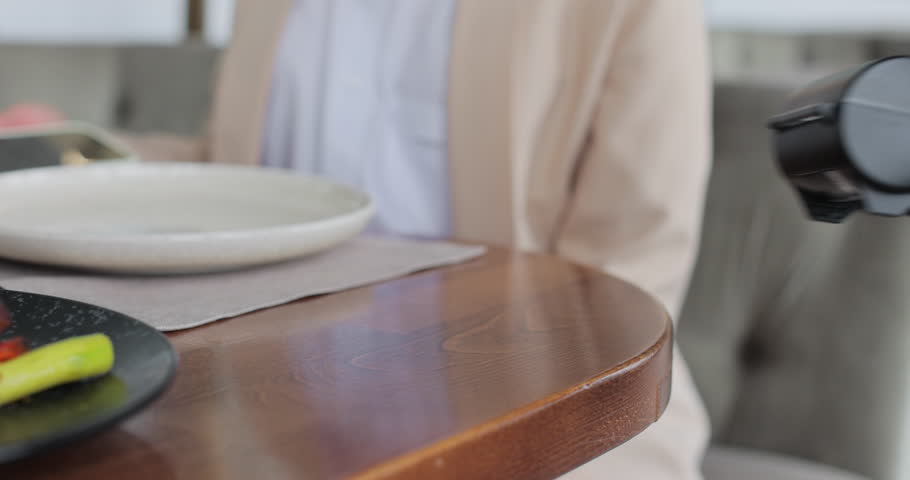 Close up hands visitor woman pay bill food order in cafe restaurant. Waiter giving terminal for cashless payment to woman. Technology device concept.