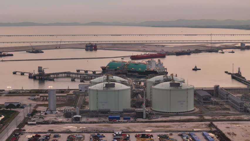 LNG (Liquified Natural Gas) tanker anchored in Gas terminal gas tanks for storage. Oil Crude Gas Tanker Ship. LPG at Tanker Bay Petroleum Chemical or Methane freighter export import transportation