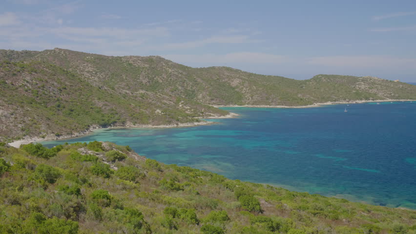 Saint-Florent Corsica panorama coast sunny view of crystal clear turquoise water, rocky shorelines under a bright blue sky serene Mediterranean landscape northern Corsican seaside