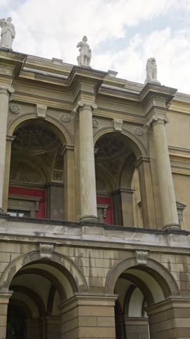 A breathtakingly stunning view of a classic building showcasing elegant arches and intricate decorative statues. MUNICH, GERMANY - OCTOBER 03, 2025