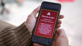 The video focuses on a smartphone screen showing an explicit banking security alert regarding fraudulent activity and money withdrawal attempts. Ideal for educational content about financial protectio - Powered by Shutterstock - Get 15% off with code: PIKWIZARD15