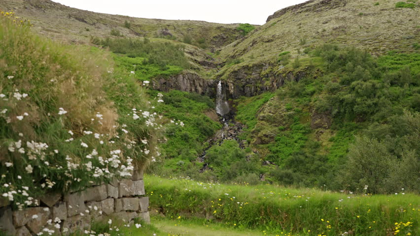 Viking Turf House with Waterfall in Background