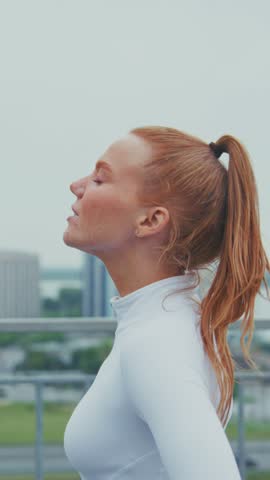 Elegant Profile of a Young Woman Enjoying a Moment of Peace in Urban Landscape, Capturing Serenity and Confidence in Her Expression Against a City Backdrop