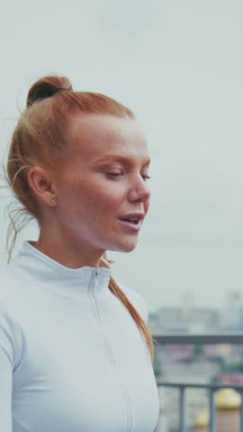 A Focused Athlete in Motion: Capturing the Determination and Grace of a Female Runner Preparing for a Challenging Workout Against a Dynamic Urban Background