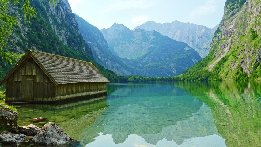 Obersee Lake, Fischunkelalm Wooden Cabin and Mountains on Sunny Day. Ripple and Reflection on Water. Bavaria, Germany
