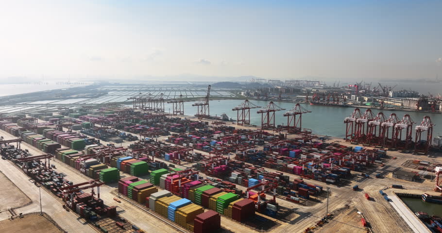 Unloading large cargo containers seaport. Loading freight sea port. Top aerial drone view. Lot big boxes rows, ship delivery ocean harbor. Industrial Shipping day. Goods export import. Marine dock.