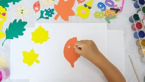 Autumn crafts. Child making colorful fun leaves from paper and plasticine. Back to school. Ideas for children's art and drawing - Powered by Shutterstock - Get 15% off with code: PIKWIZARD15