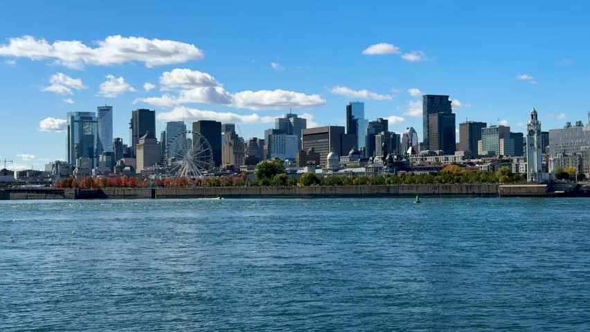 Montreal, Canada - October 08, 2025: Montreal skyline photographed from Parc Jean-Drapeau. The St. Lawrence River in the foreground.