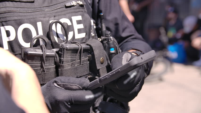 Close up police officer on tablet booking fentanyl dealer