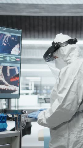 Vertical Video Medic in protective gear collecting data on infection spread, observing symptoms of patient in isolation and quarantine. Analyzing antibiotics and antiviral therapy for disease control