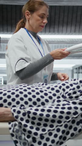 Vertical Video Researcher uses magnifying glass in a clinical trial evaluating patient health during drug testing, observing dosage reactions. Studying outcomes for discovery and progress in science