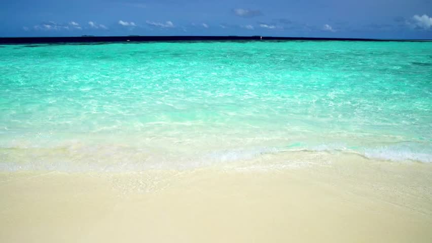 Tropical beach with turquoise water and white sand on a sunny summer day view