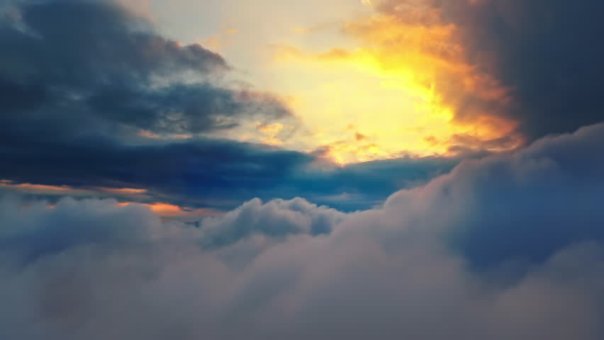 Aerial shot of flying through magnificent sea of clouds with a dramatic and colorful sunset sky in the background