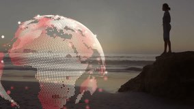 woman using handheld device on rocky beach at dusk, with glowing digital globe technology overlay. Futuristic, technology, innovation, digital, connectivity, serene, informed - Powered by Shutterstock - Get 15% off with code: PIKWIZARD15
