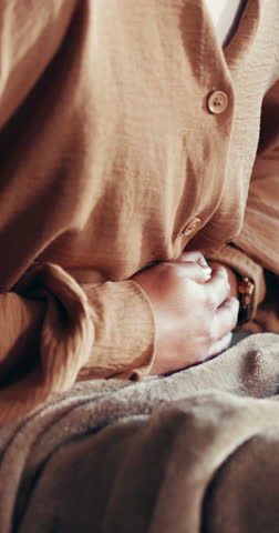 Stomach ache, hands or woman on couch with period pain, menstrual cycle or endometriosis for discomfort. Cramps, bloating or person in home with sore abdomen, gastro or constipation for tummy problem