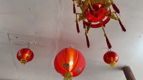 Red Chinese lanterns hang from a white ceiling, camera tilts upward, soft indoor lighting - Powered by Shutterstock - Get 15% off with code: PIKWIZARD15