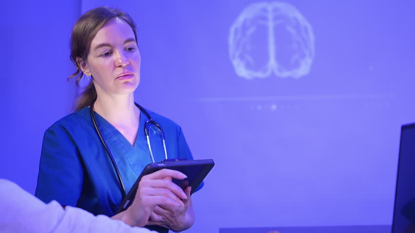 Doctors and medical professionals discuss preparing for physical and brain with futuristic hologram technology in a modern hospital setting - Powered by Shutterstock - Get 15% off with code: PIKWIZARD15