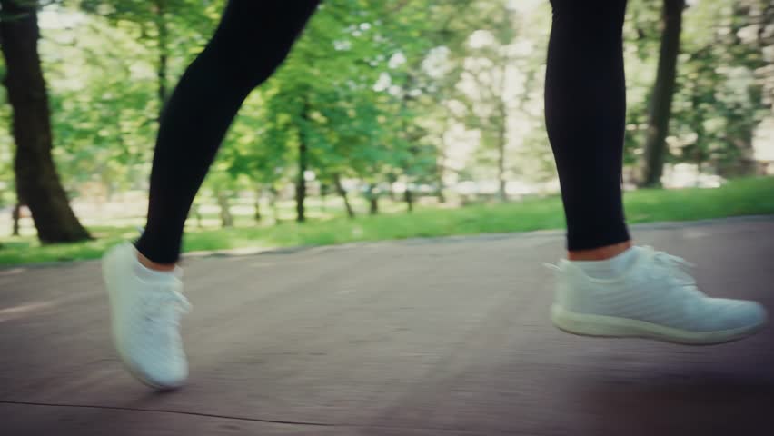 Close-up Of Female Legs Running On A Park Pathway