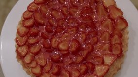 Top view of a strawberry tart covered with sliced fruit and shiny glaze on a dessert plate - Powered by Shutterstock - Get 15% off with code: PIKWIZARD15