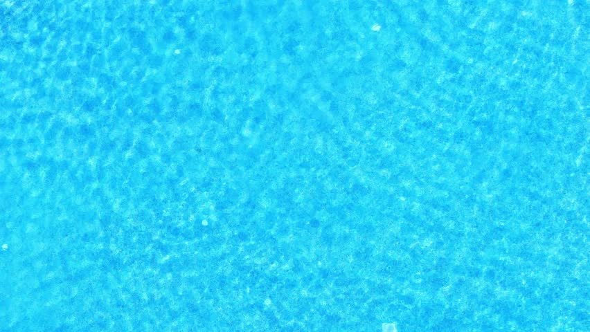 Beautiful refreshing blue swimming pool Water surface texture, clean swimming pool ripples and waves in slow motion