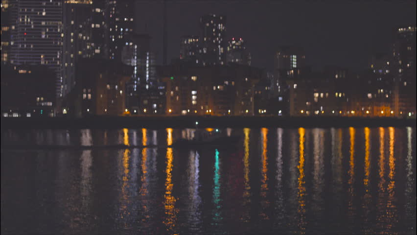 River Thames Night View with Boat, Canary Wharf in London from Rotherhithe.