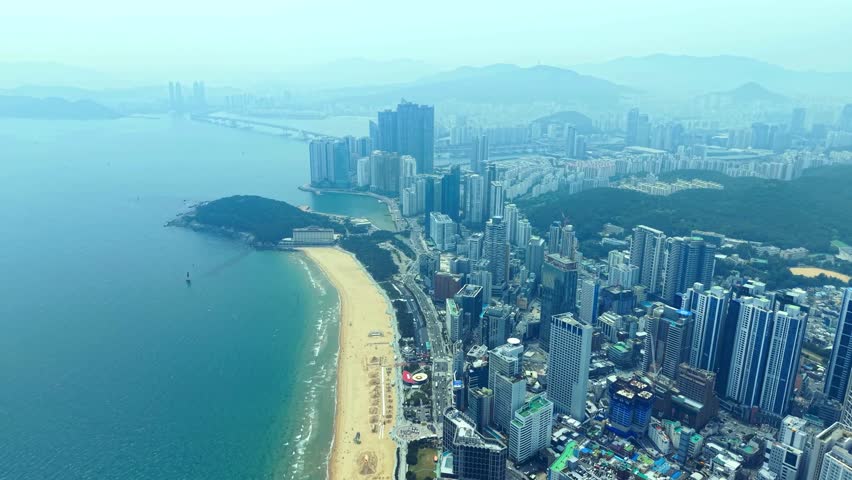 Aerial over Haeundae Beach, Marine City skyline, Busan