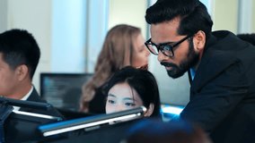 Indian manager explaining and training work to team colleagues. Advising trainee programmer on a complex code. Concept of mentorship and teamwork in technology. IT support at late work - Powered by Shutterstock - Get 15% off with code: PIKWIZARD15