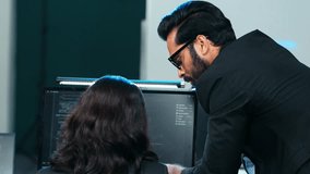 Indian software engineer team analyzing and debugging code on a computer monitor in a modern tech office, reviewing complex data and programming, work in cybersecurity, system maintenance - Powered by Shutterstock - Get 15% off with code: PIKWIZARD15