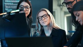 Diverse team of business professionals and developers collaborating on a digital project, focusing on code and data analysis in a dark, tech-savvy office. Cybersecurity and IT work. - Powered by Shutterstock - Get 15% off with code: PIKWIZARD15