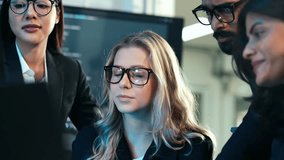 Diverse team of business professionals and developers collaborating on a digital project, focusing on code and data analysis in a dark, tech-savvy office. Cybersecurity and IT work. - Powered by Shutterstock - Get 15% off with code: PIKWIZARD15