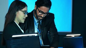 Diverse team of technology and business professionals working intently on computers in a modern, blue-lit corporate control room. Focuses on data security, IT development, and global collaboration. - Powered by Shutterstock - Get 15% off with code: PIKWIZARD15