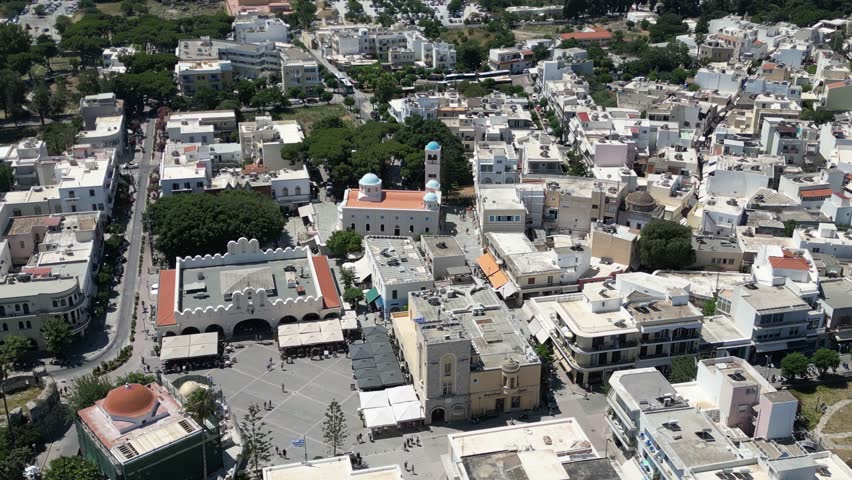 Aerial view of the city center bustling with life, showcasing buildings with distinct architectural styles, Kos, Greece.
