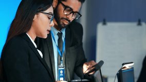 Diverse team of technology and business professionals working intently on computers in a modern, blue-lit corporate control room. Focuses on data security, IT development, and global collaboration. - Powered by Shutterstock - Get 15% off with code: PIKWIZARD15