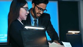 Diverse team of IT and business professionals focused on data analysis and technology in a secure, blue-lit control room environment. Excellent for concepts of corporate security and digital work. - Powered by Shutterstock - Get 15% off with code: PIKWIZARD15