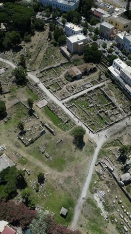 Aerial view of the Ancient Agora ruins, a captivating blend of tan ruins and green grass, Kos, Greece.