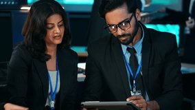 Multicultural business professionals working intensely on digital devices and analyzing data in a corporate office. Focused teamwork, IT development, and cybersecurity, brainstorming project - Powered by Shutterstock - Get 15% off with code: PIKWIZARD15