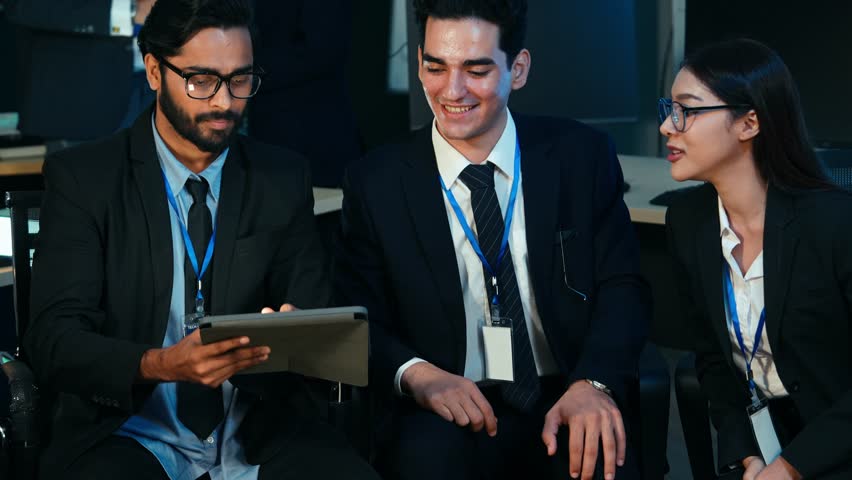 Multicultural business and IT professionals collaborating on digital devices, analyzing data, and discussing strategy in a modern tech office. Concepts of teamwork, innovation, and global  - Powered by Shutterstock - Get 15% off with code: PIKWIZARD15