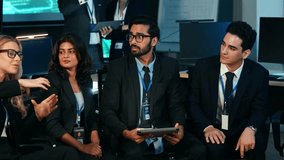 Diverse team of business professionals and IT experts actively viewing a presentation, discussing strategy, and collaborating in a modern, dark tech office. Corporate leadership and innovation - Powered by Shutterstock - Get 15% off with code: PIKWIZARD15