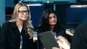 Diverse team of IT and business professionals actively listening to a colleague's presentation, collaborating, and analyzing code in an office. Developer team join the meeting - Powered by Shutterstock - Get 15% off with code: PIKWIZARD15