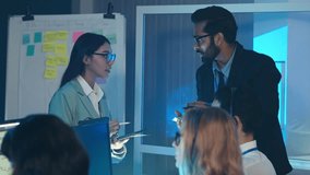 Business professional leads a late-night team meeting, presenting key project data. Demonstrates leadership, communication, and planning with support agents or call center. Customer service - Powered by Shutterstock - Get 15% off with code: PIKWIZARD15