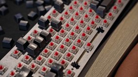 Time lapse video showing man assembling mechanical keyboard, installing keycaps on red switches. Concept of DIY, electronics repair, and computer hardware maintenance - Powered by Shutterstock - Get 15% off with code: PIKWIZARD15